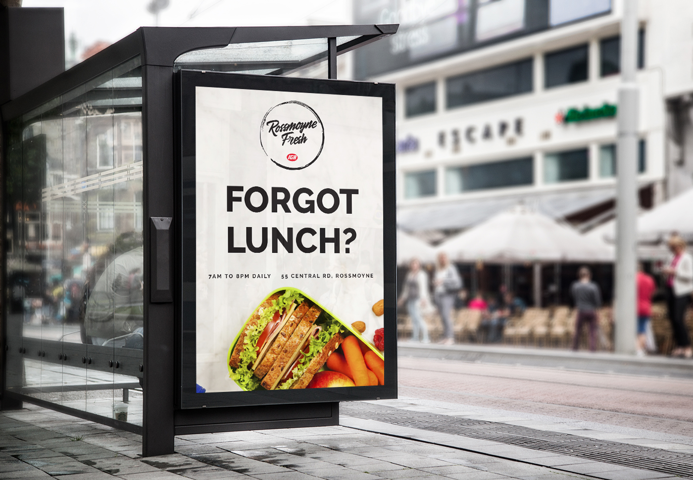 An ad at a bus stop for Rossmoyne Fresh saying "FORGOT LUNCH?" with a sandwich picture.