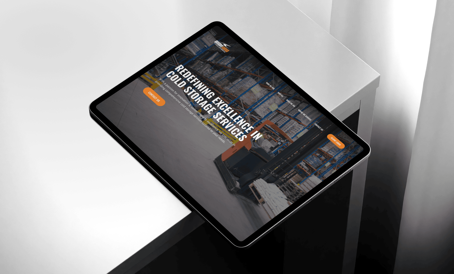 Tablet displaying a website about cold storage services, shown in a modern warehouse setting.