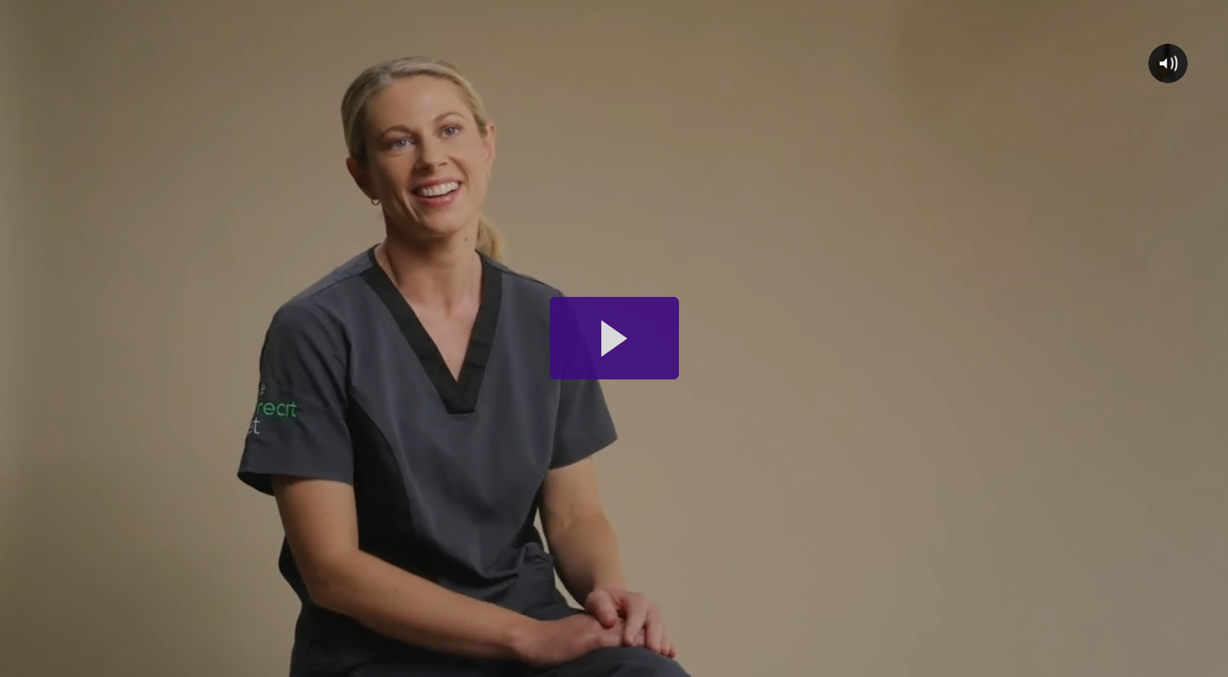 A photo of a blonde nurse sitting on a chair being interviewed.