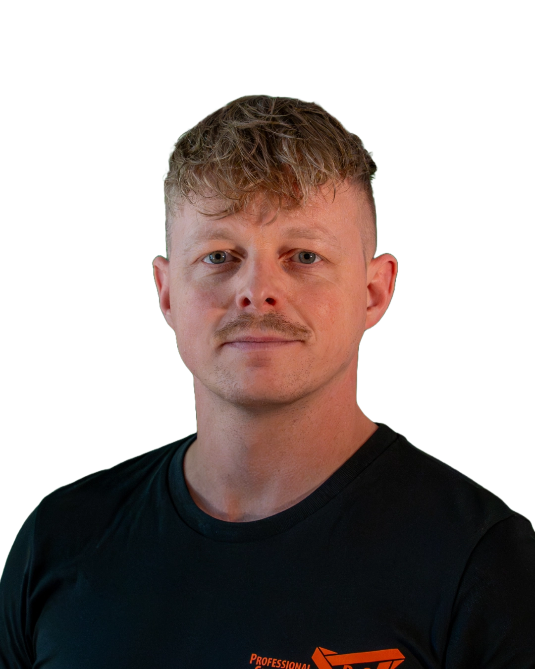 Portrait of a man with short curly hair and a mustache wearing a black shirt with orange text.