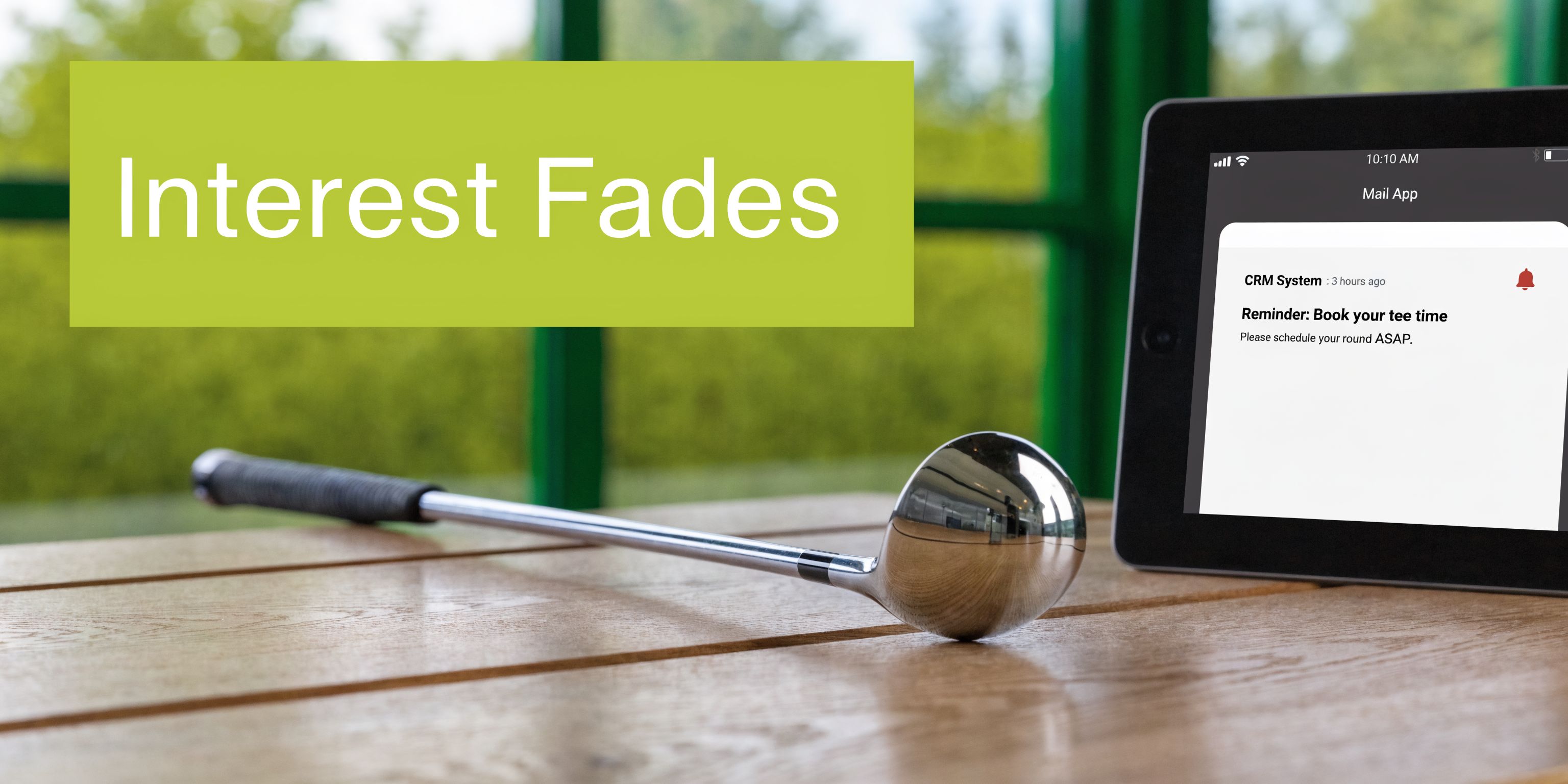 A golf club sits on a wooden table next to a tablet displaying a golf reminder notification.