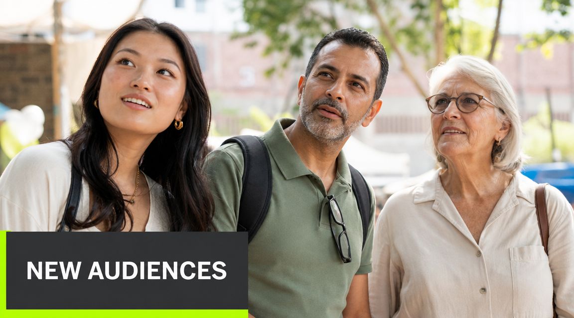 A diverse group of three adults looking up while standing together outdoors in a sunny park.