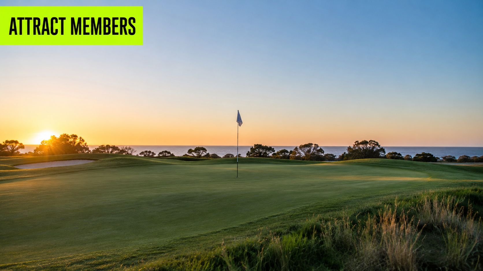 A serene golf course putting green at sunrise overlooking the ocean with a flagstick in the distance.