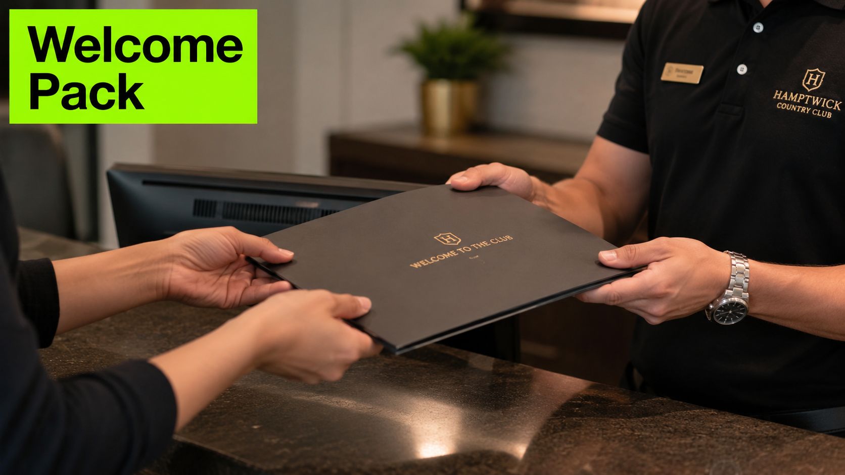 A club staff member handing a professional black welcome folder to a new club member.