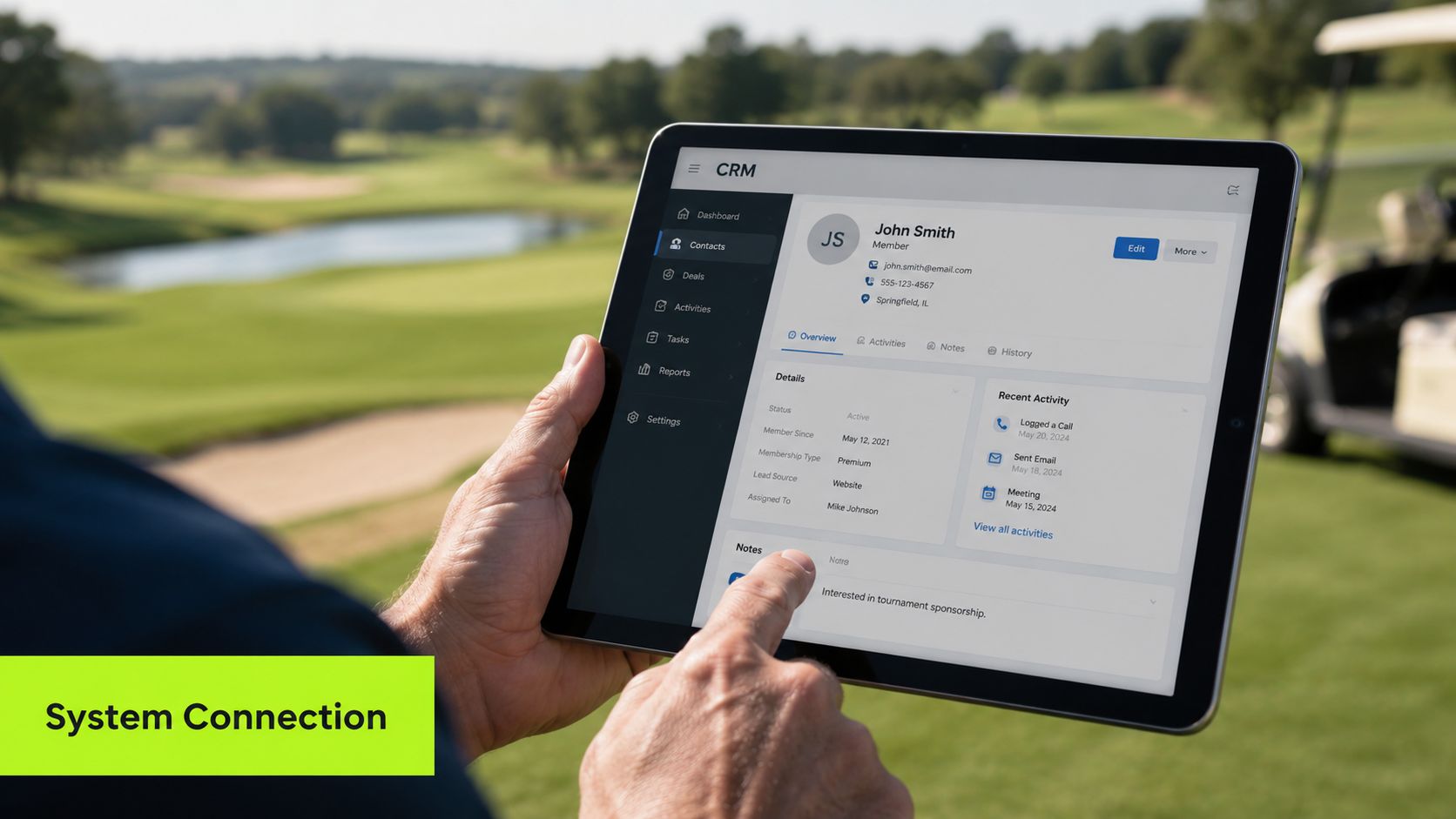 A person holding a tablet displaying a CRM dashboard while standing on a golf course.