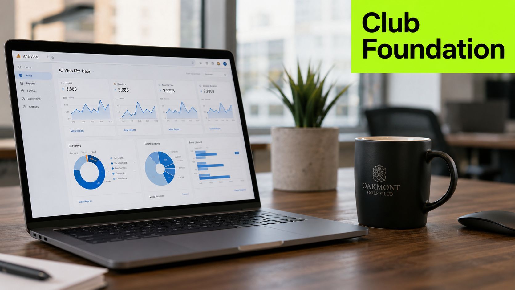A laptop showing analytics data on a wooden desk next to an Oakmont Golf Club mug.