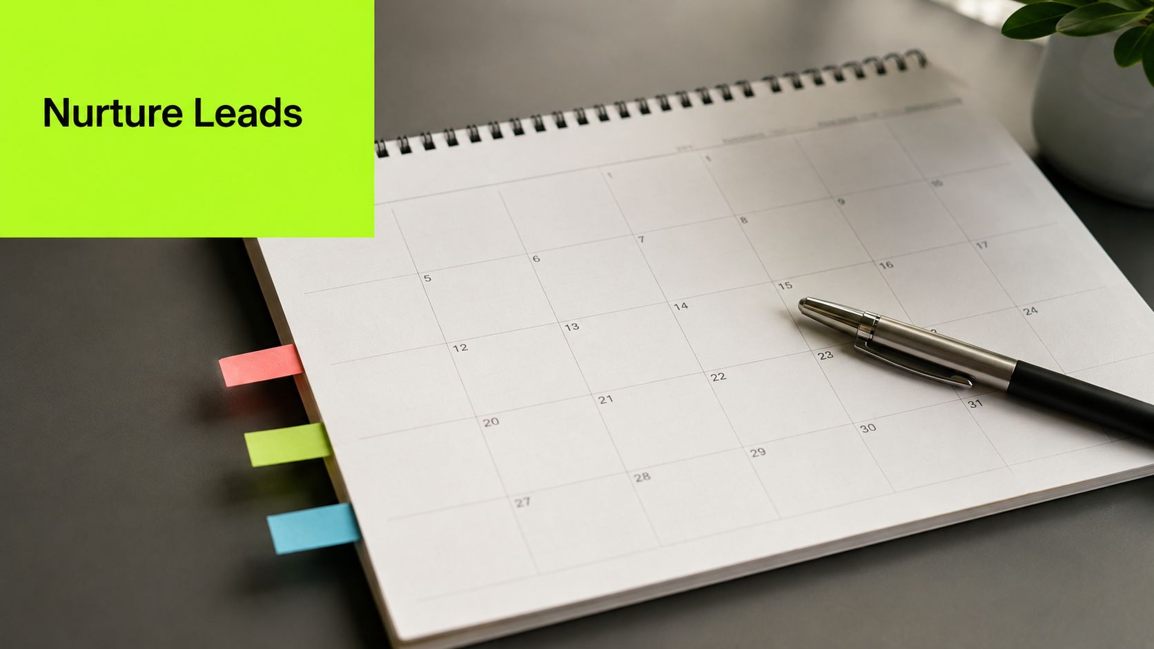 A calendar on a desk with a pen and colored sticky tabs for planning marketing tasks.