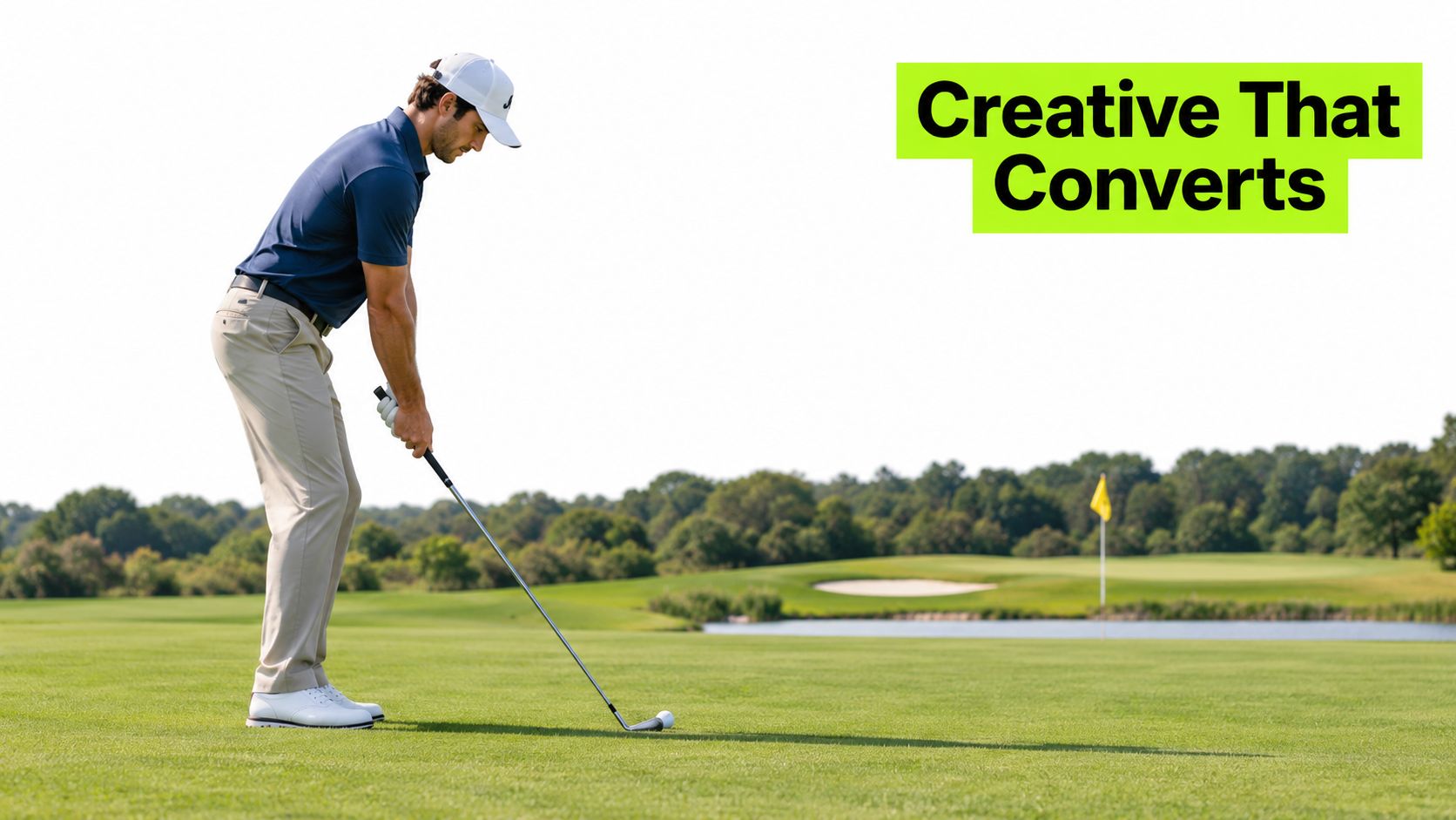 A professional golfer in a blue shirt and khaki pants preparing to swing at a golf course.