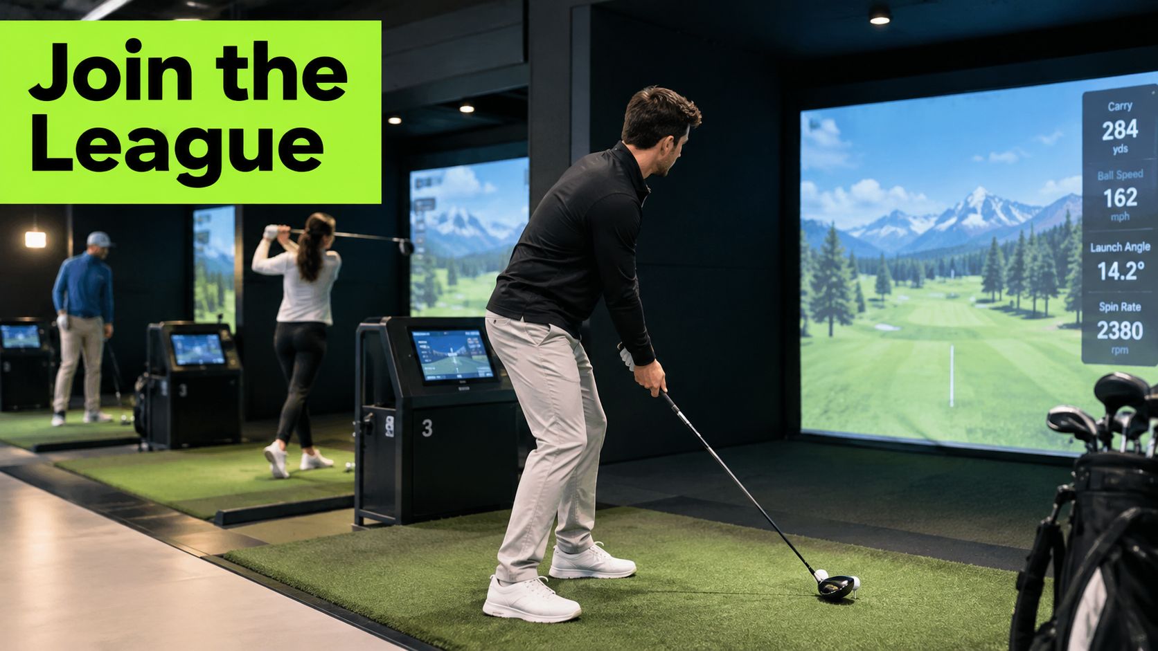 People practicing their golf swings at an indoor facility with digital simulators and tracking screens.