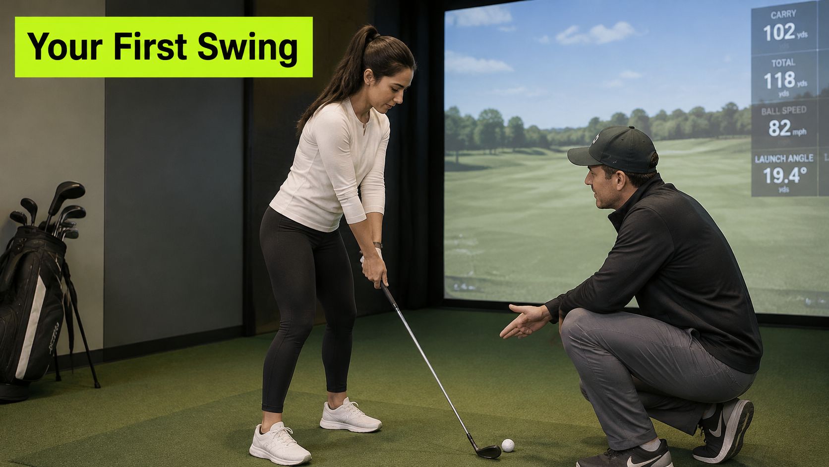 A professional golf coach instructs a woman on her golf swing in an indoor simulation studio.