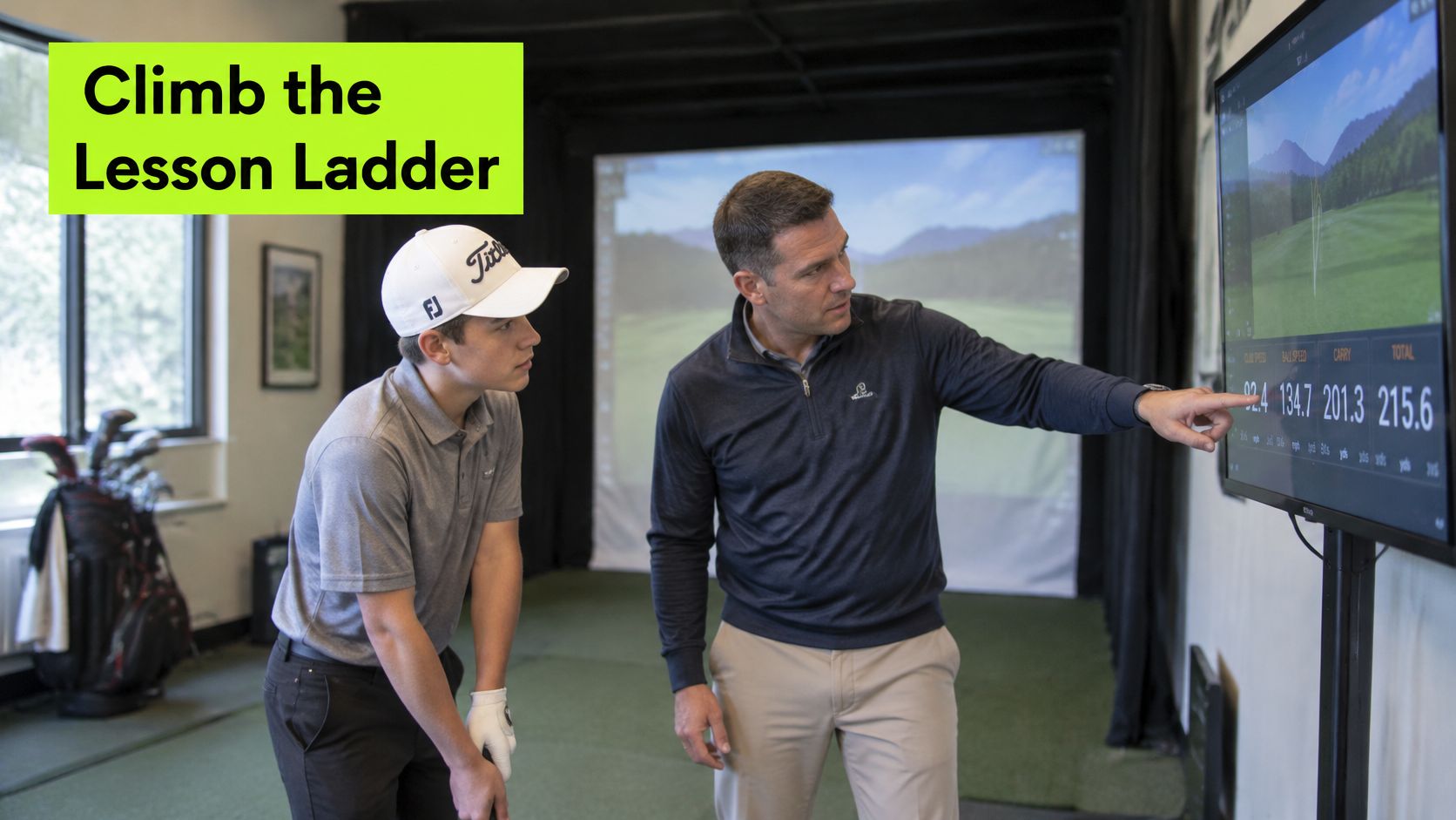 A golf instructor explains data on a simulator screen to a young student during a private lesson.