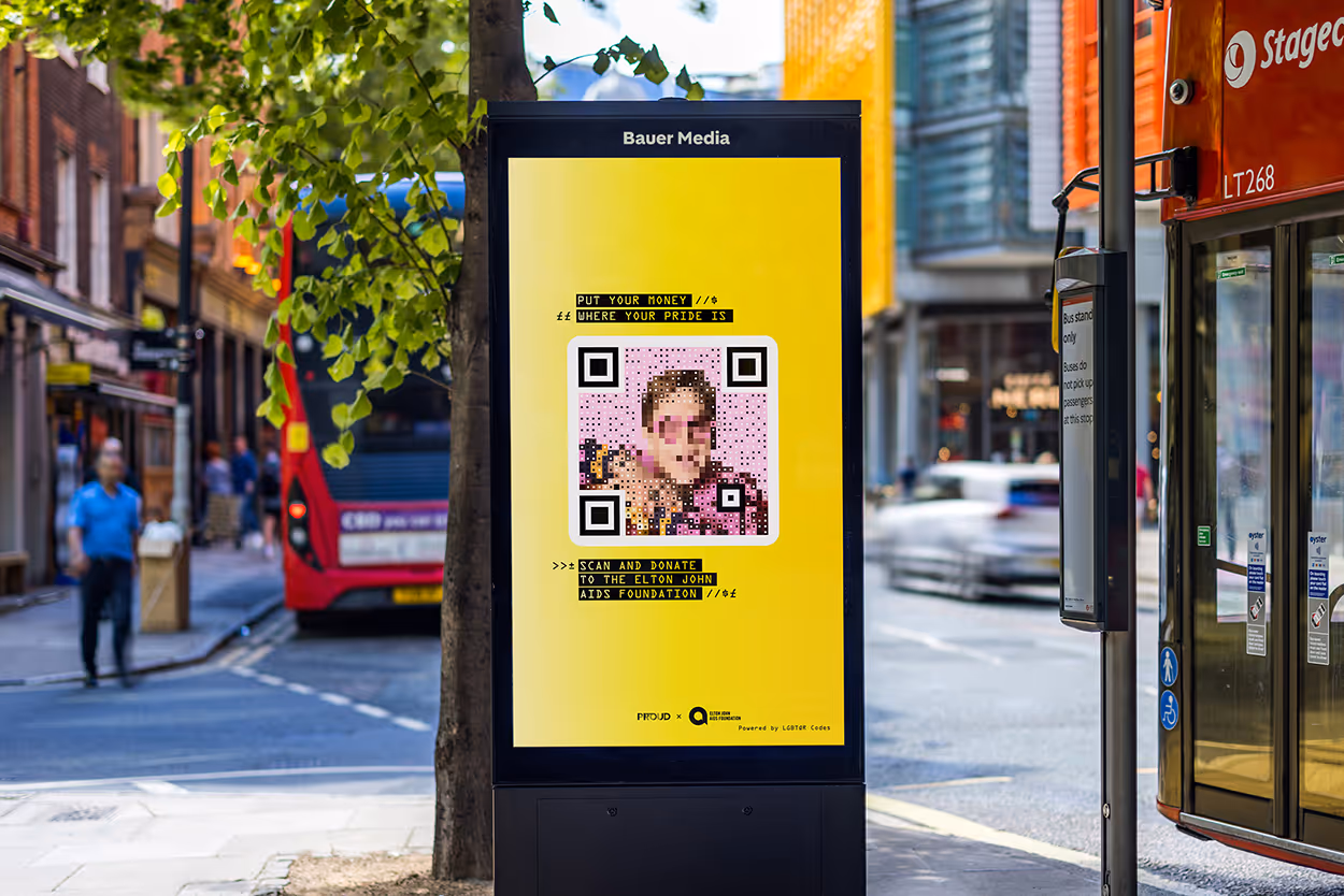 A digital screen on a high street showcasing Pride campaign in partnership with Elton John's AIDS Foundation
