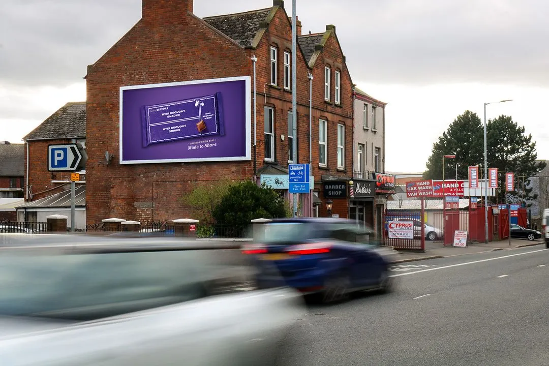 a 48-sheet billboard on the side of a busy road