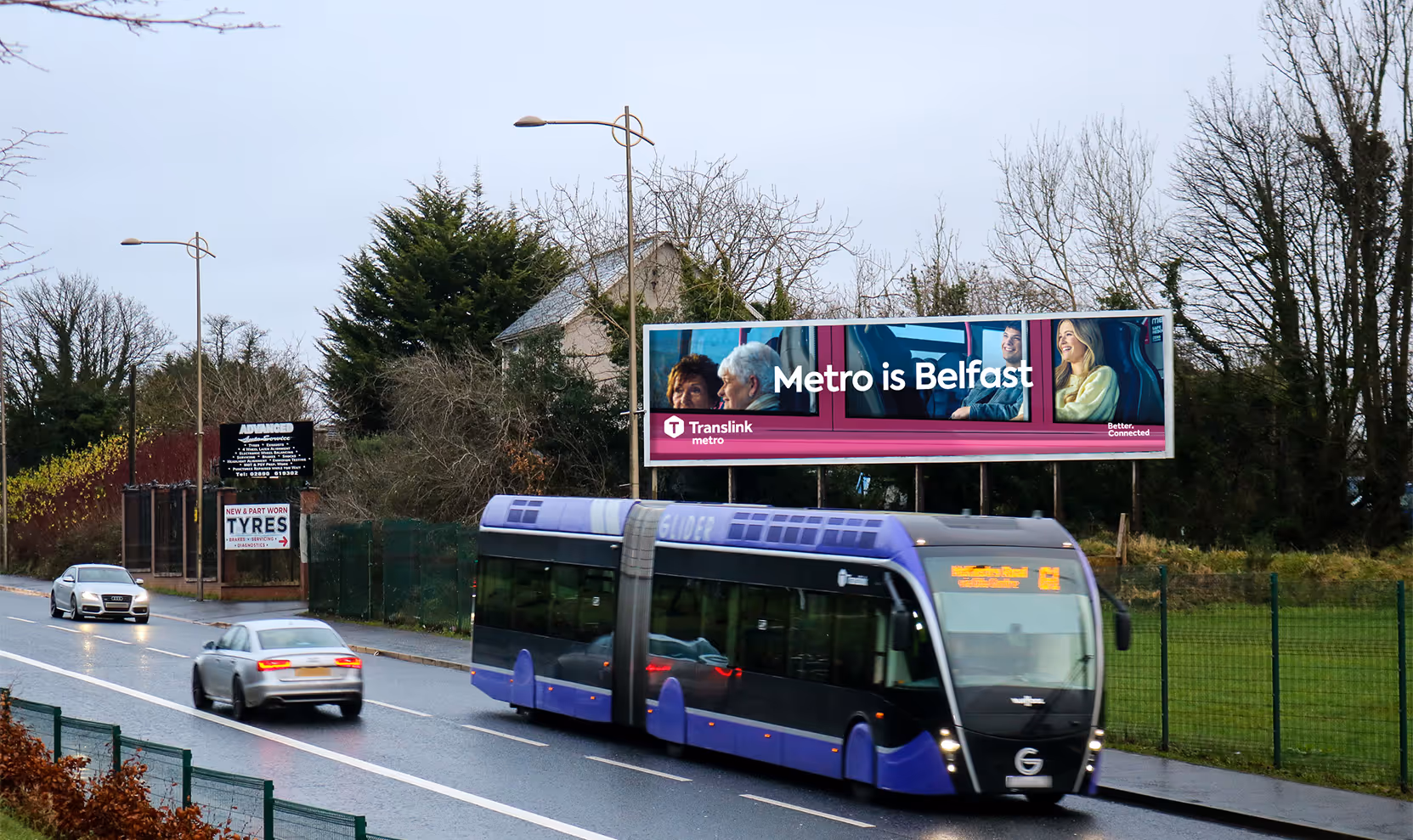 A 96-sheet billboard advertisement overlooking a busy road with traffic passing by