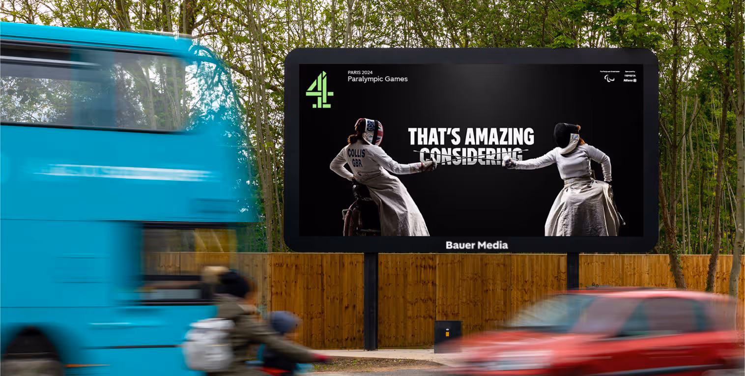 Vehicles drive past a Channel 4 Paralympic ad on a large billboard