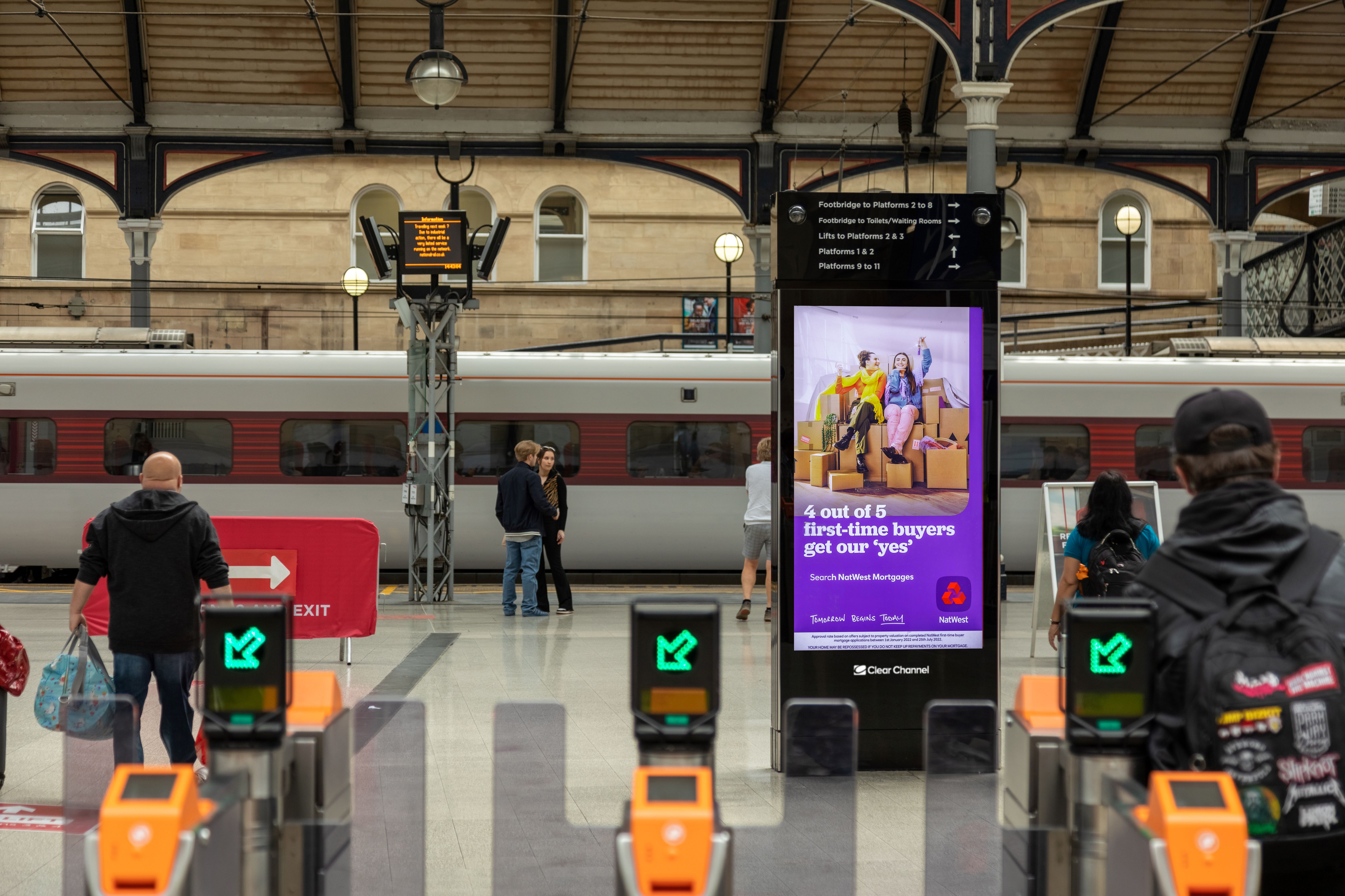 A digital advertising screen in LNER-operated train station
