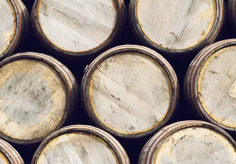 Top view of eight wooden barrels stacked closely together.