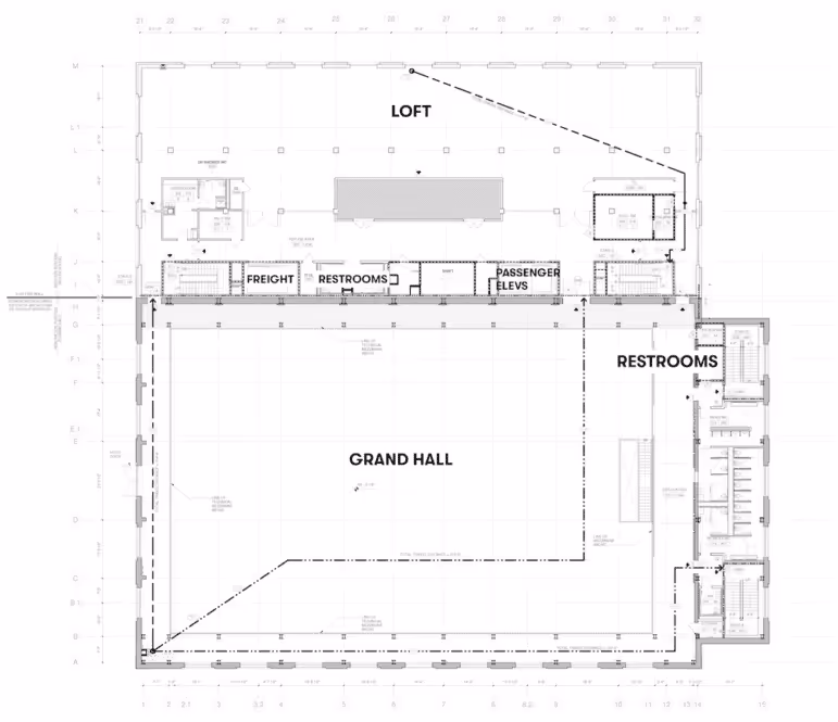 Architectural floor plan showing a large Grand Hall with adjacent restrooms, freight area, passenger elevators, and a loft area above.