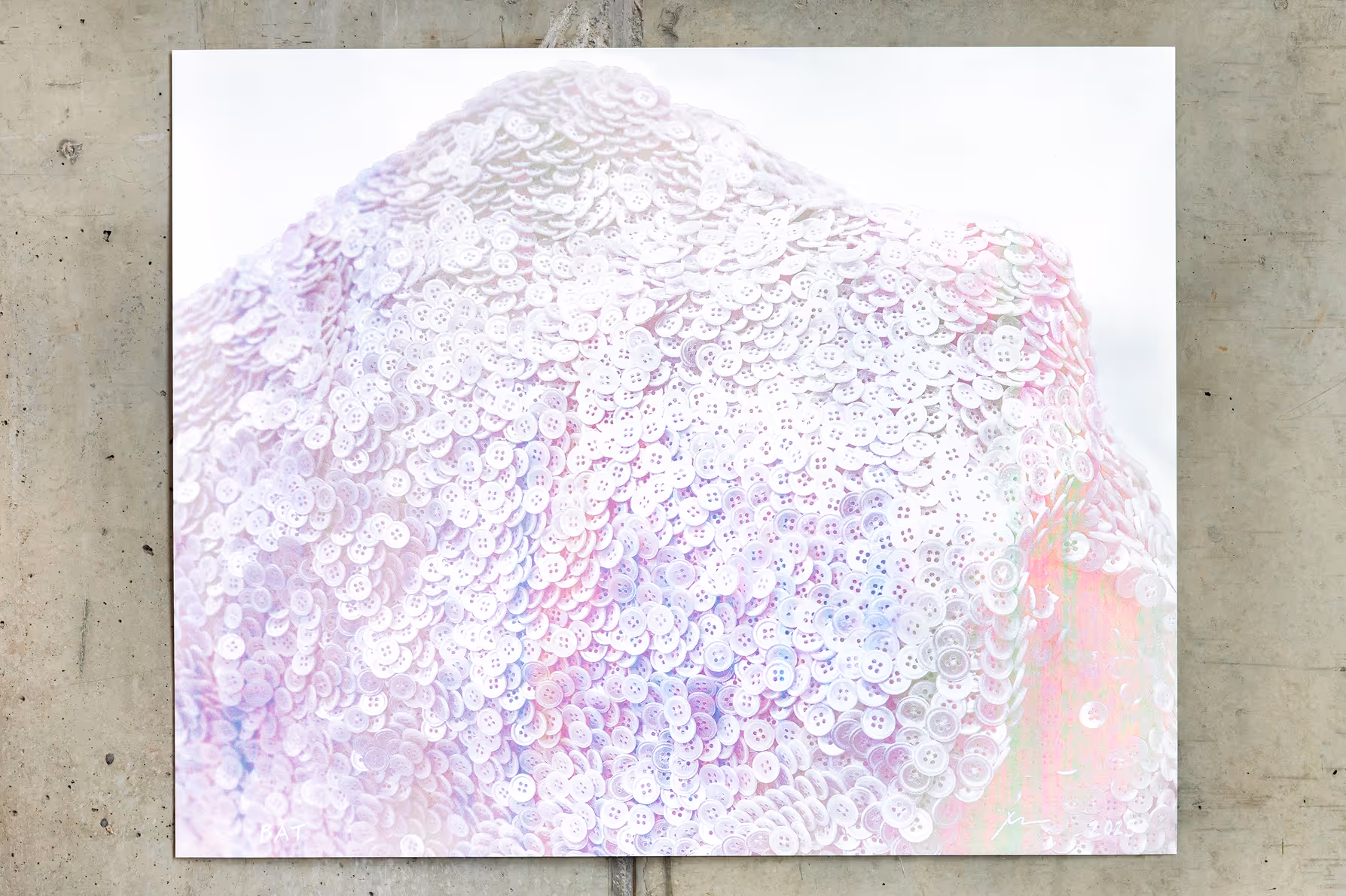 Close-up of a textured surface densely covered with white four-hole buttons arranged in overlapping layers.