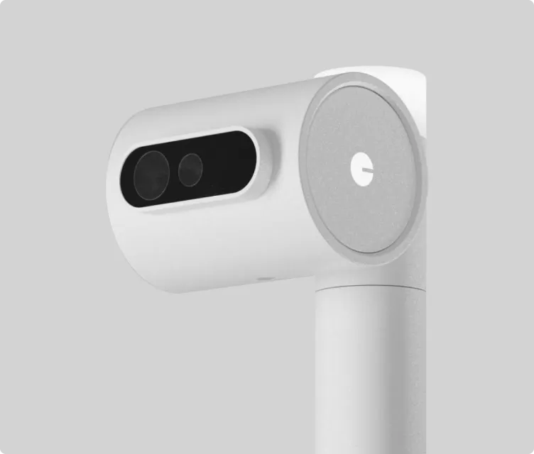 White handheld device with dual lenses on a black panel and a cylindrical handle against a light gray background.