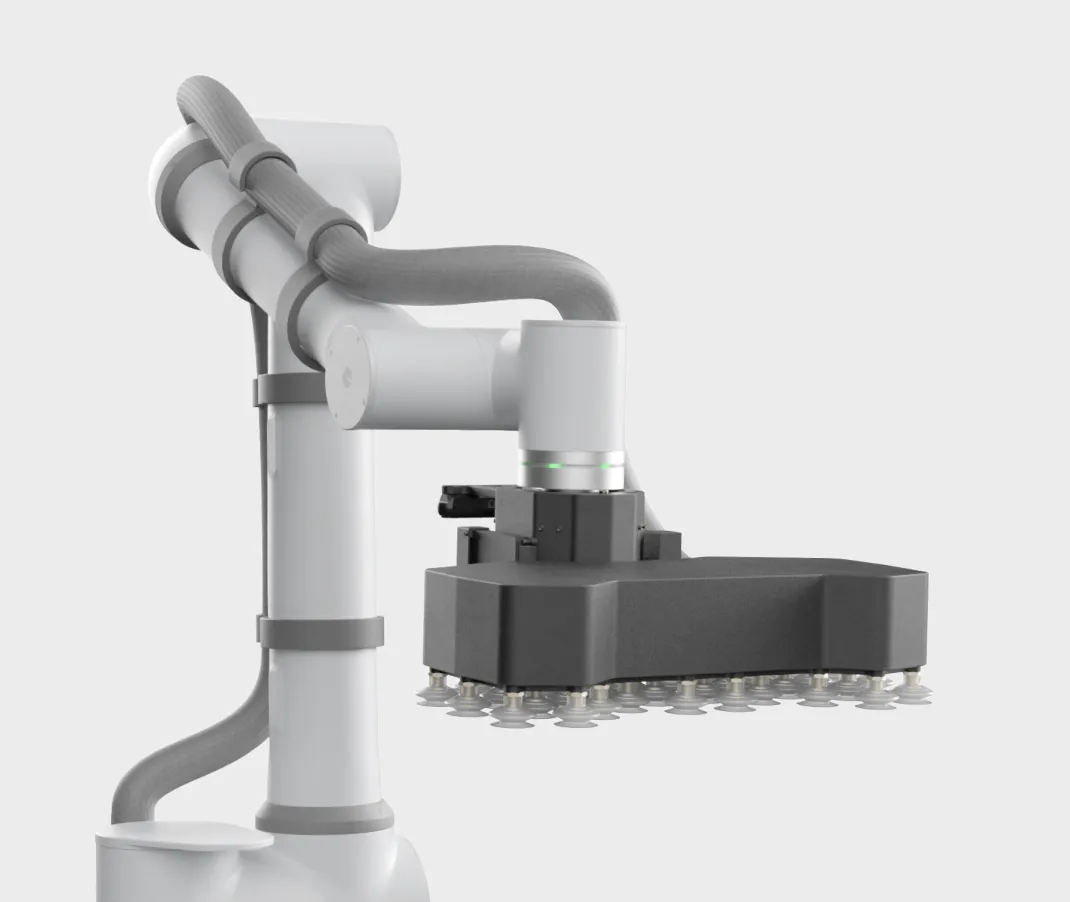 White robotic arm with a black multi-suction gripper attached at the end.
