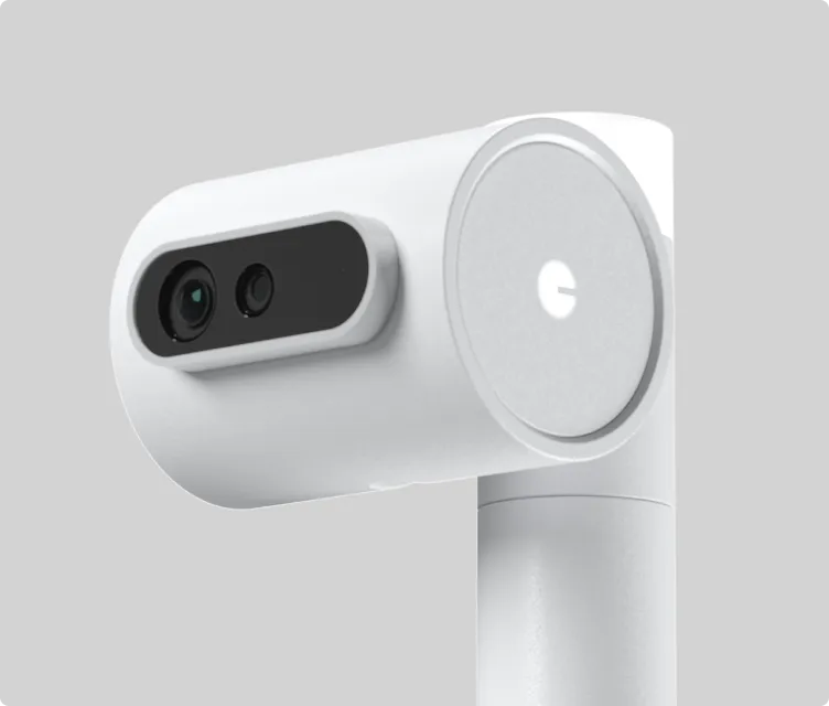 White security camera with dual lenses mounted on a vertical arm against a light gray background.