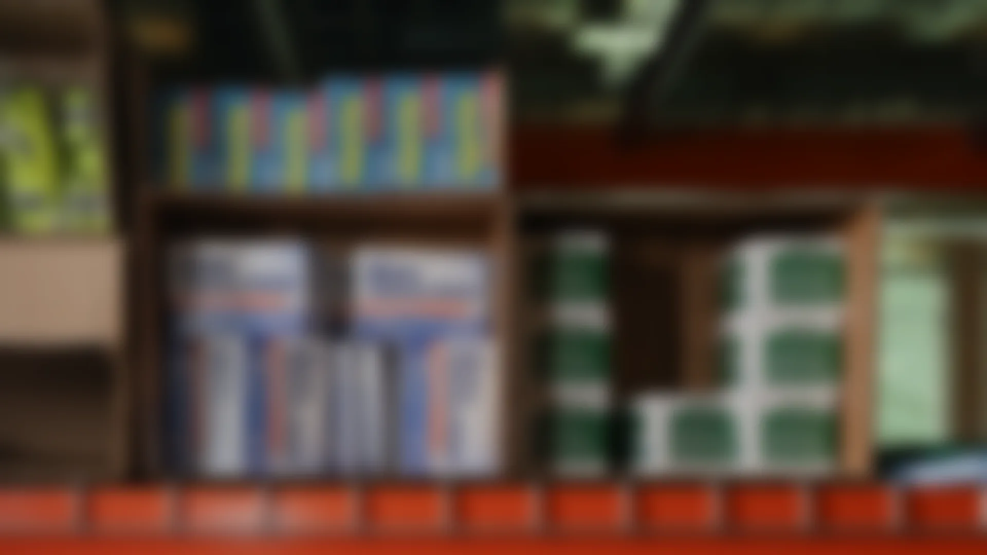Retail unit inventory, blurred, on shelves waiting robotic picking.