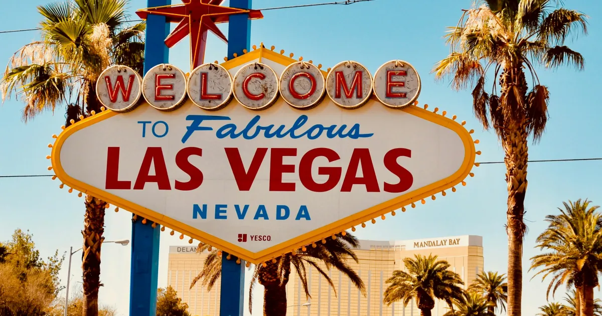 the iconic “Welcome to Fabulous Las Vegas” sign with palm trees in the background