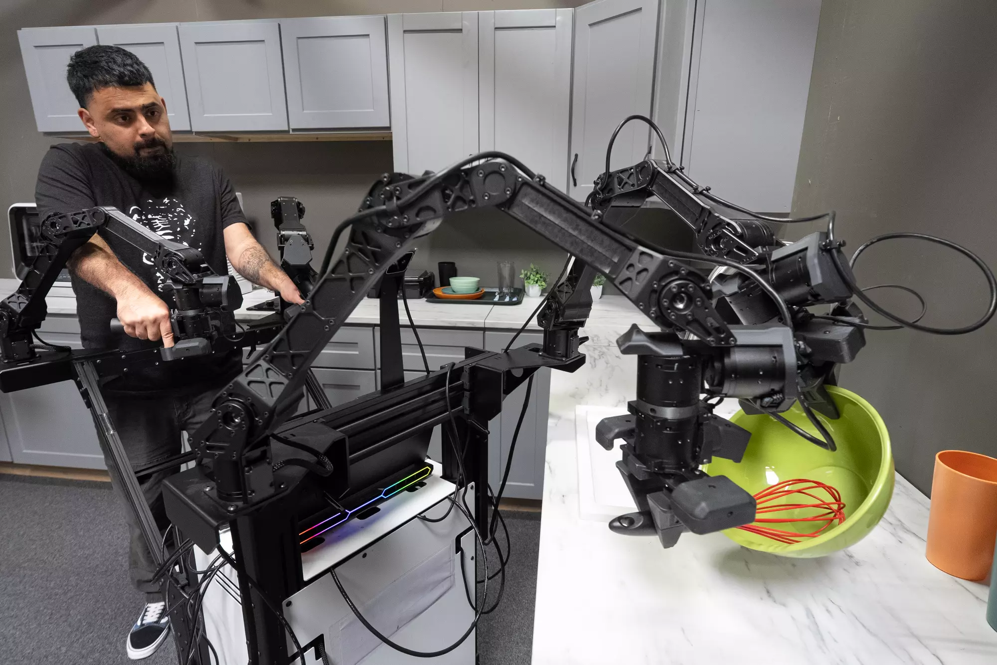 Fernando Flores demonstrates the articulation of a robot performing a whisking motion at Encord on May 21.
