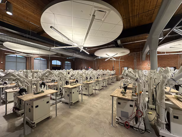 A fleet of 100 Sonny robots collecting data to train robot foundation models.