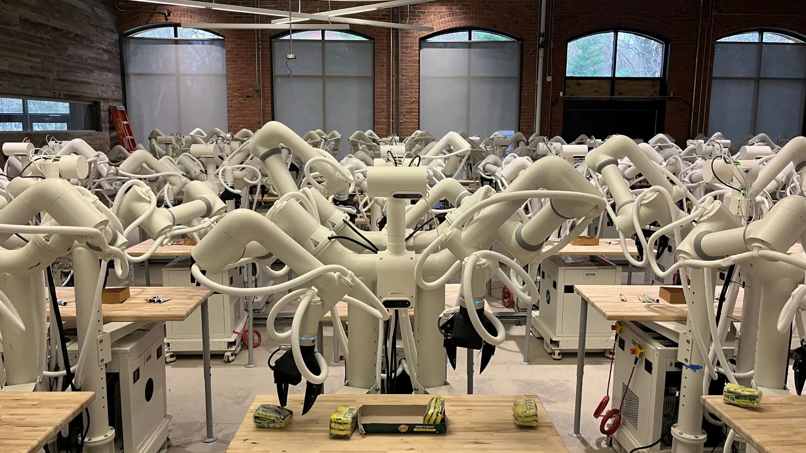 A fleet of 100 Sonny robots collecting data to train robot foundation models.