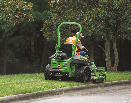 John Deere mowing along the curb