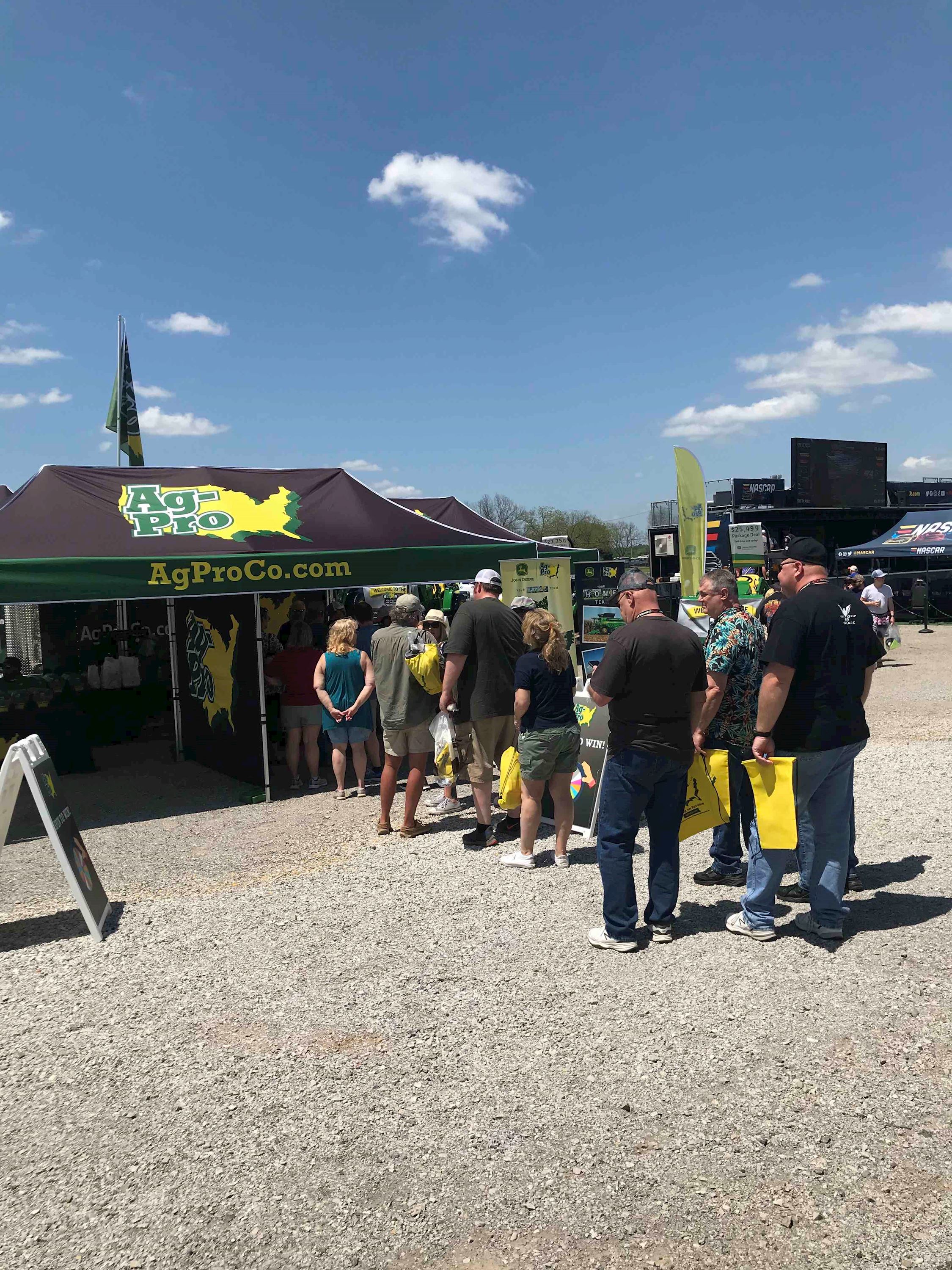 Fans line up for free swag at the Ag-Pro 300 booth in the FanZone. 