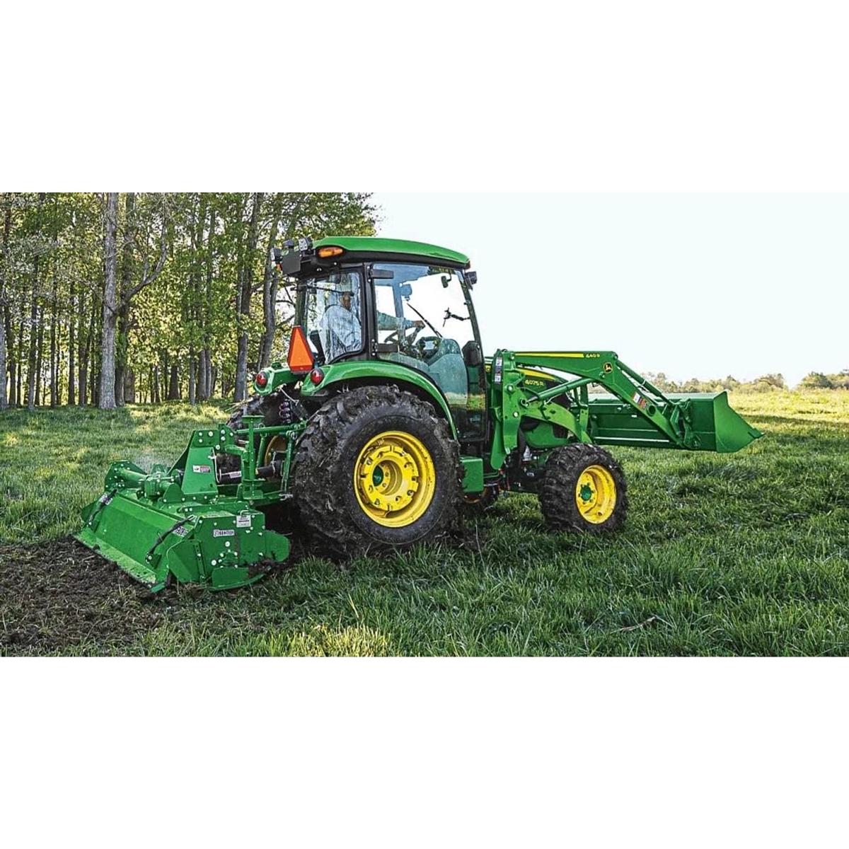 4075R Compact Tractor with a large front end loader in a field