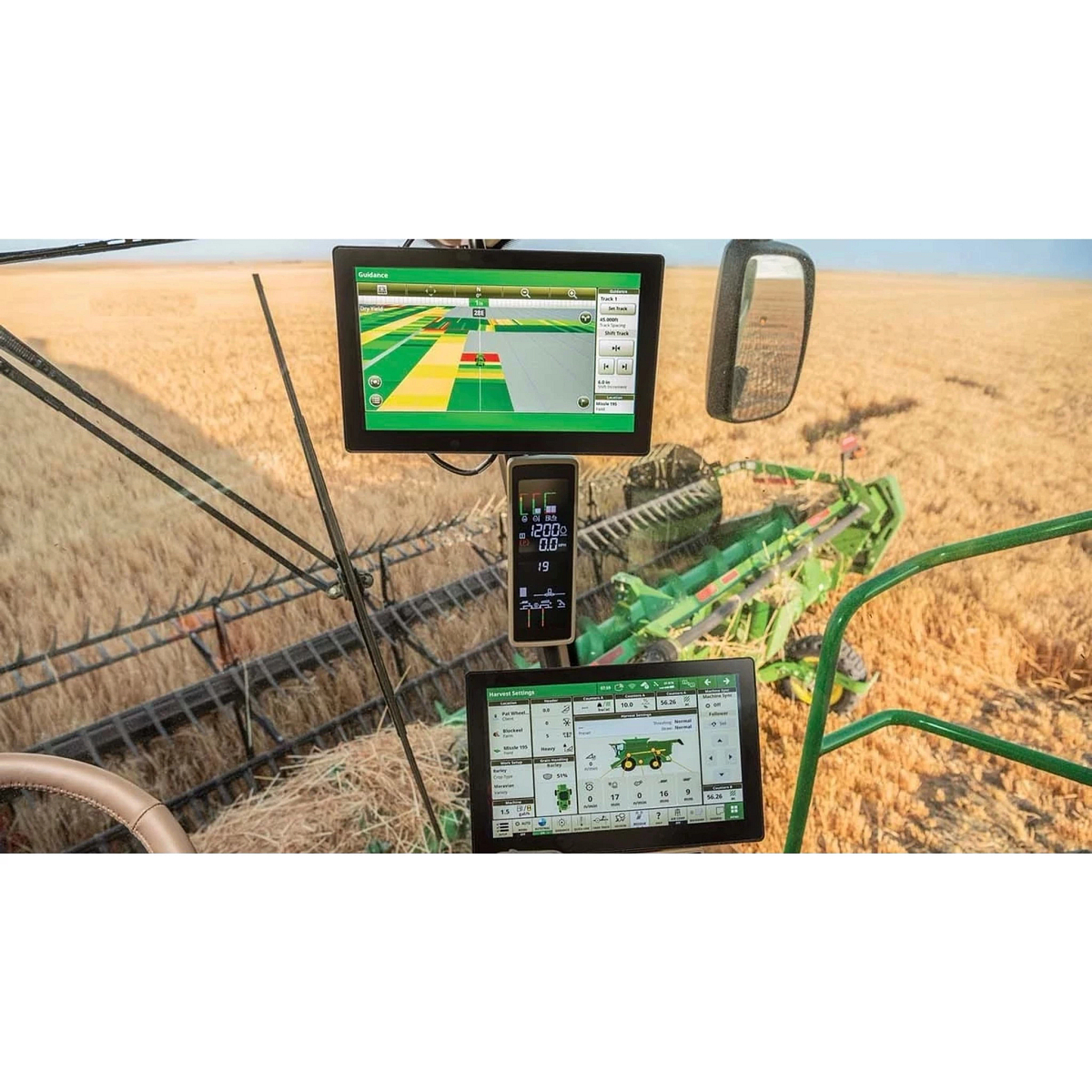 Precision agriculture displays inside combine cab monitoring harvesting operations