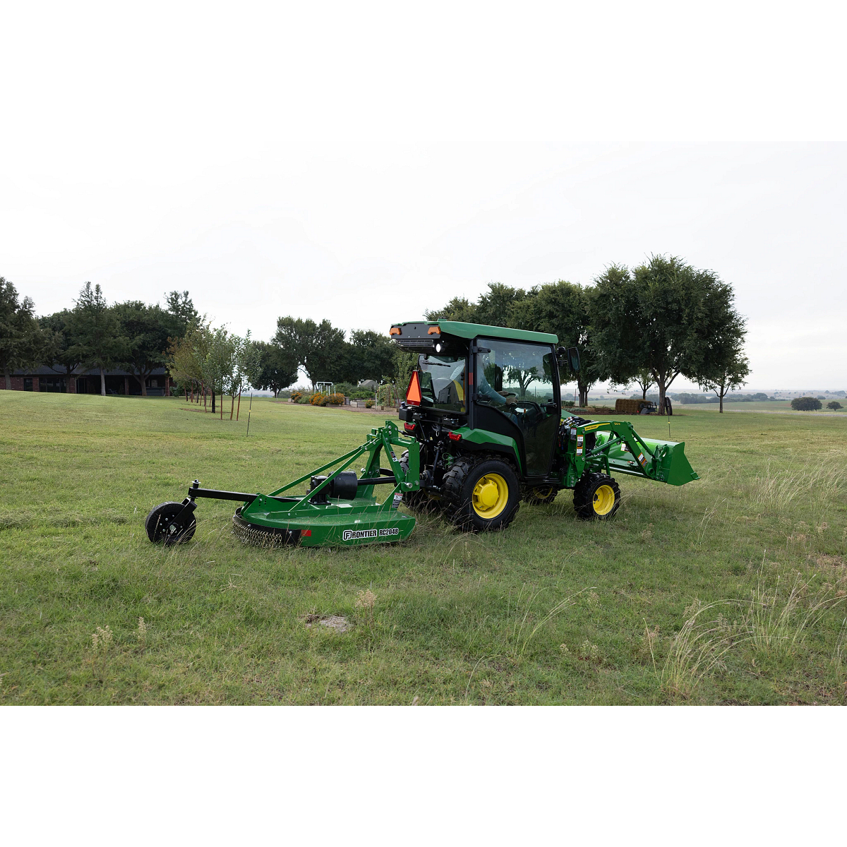 RC2048 Rotary Cutter on utility tractor in grassy field