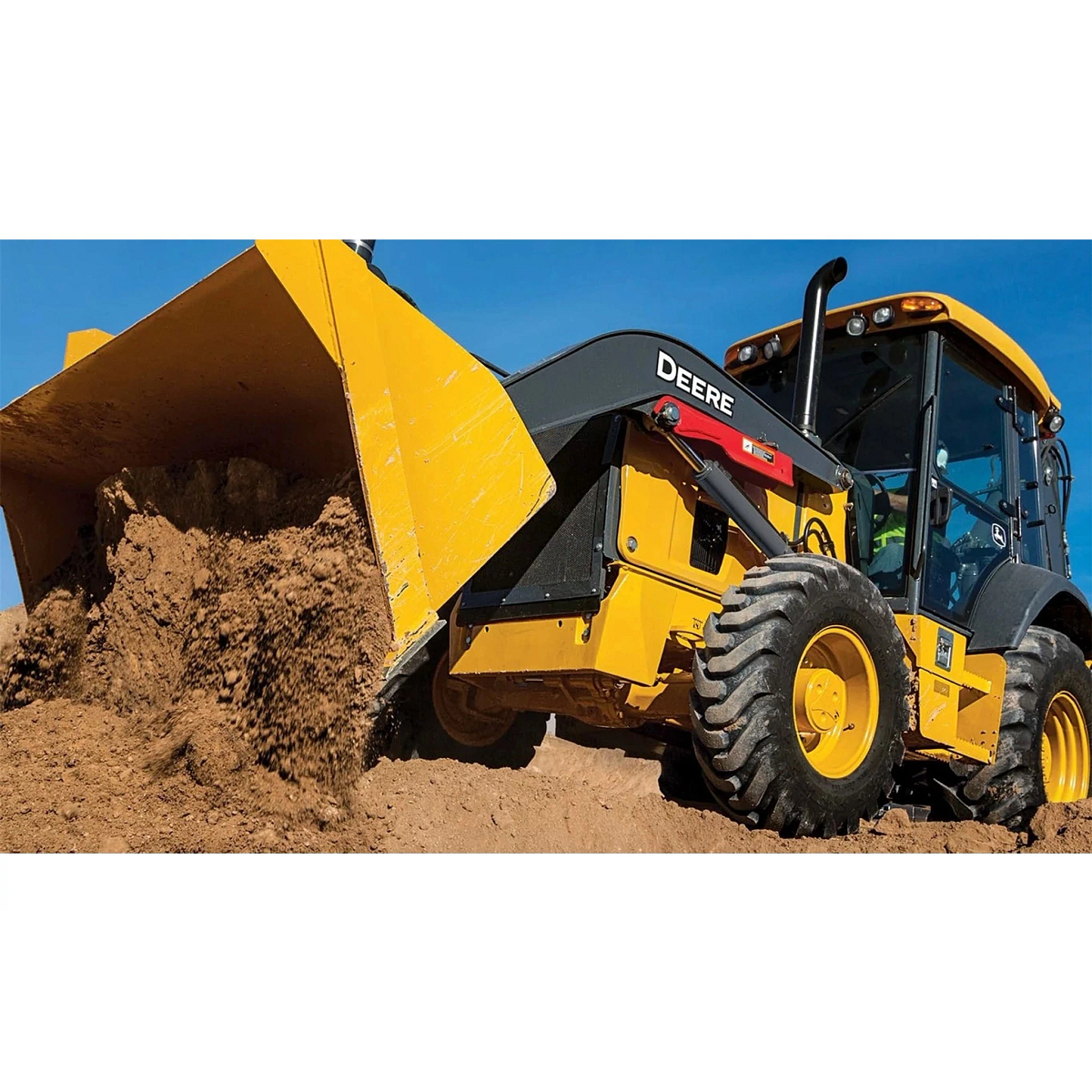 310 P-Tier Backhoe Loader dumping dirt into a pile