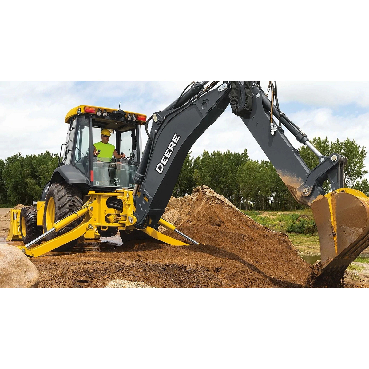 An operating moving large piles of dirt with a 710 P-Tier Backhoe