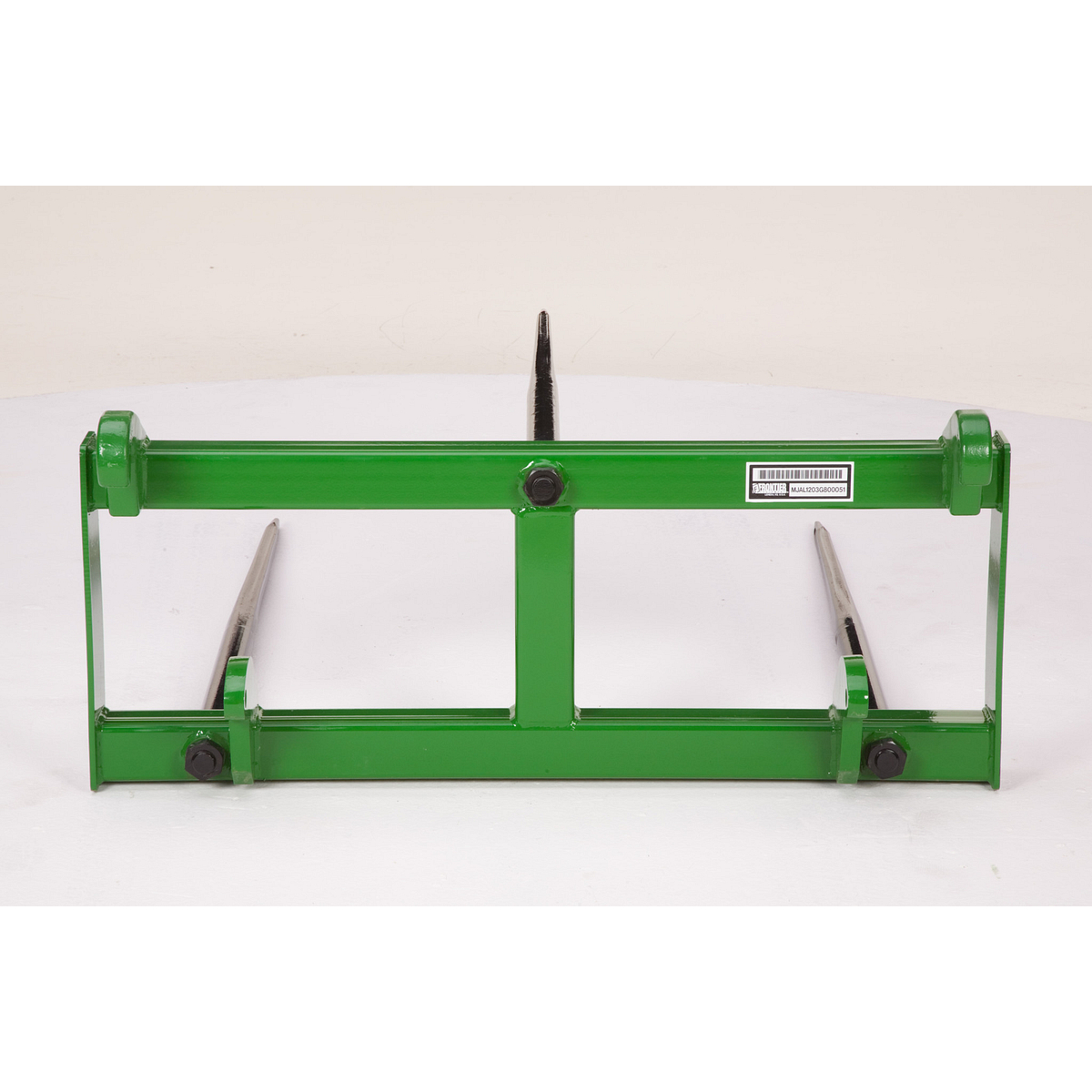 A green pallet‑fork frame with two long steel tines extending forward, displayed against a plain background.