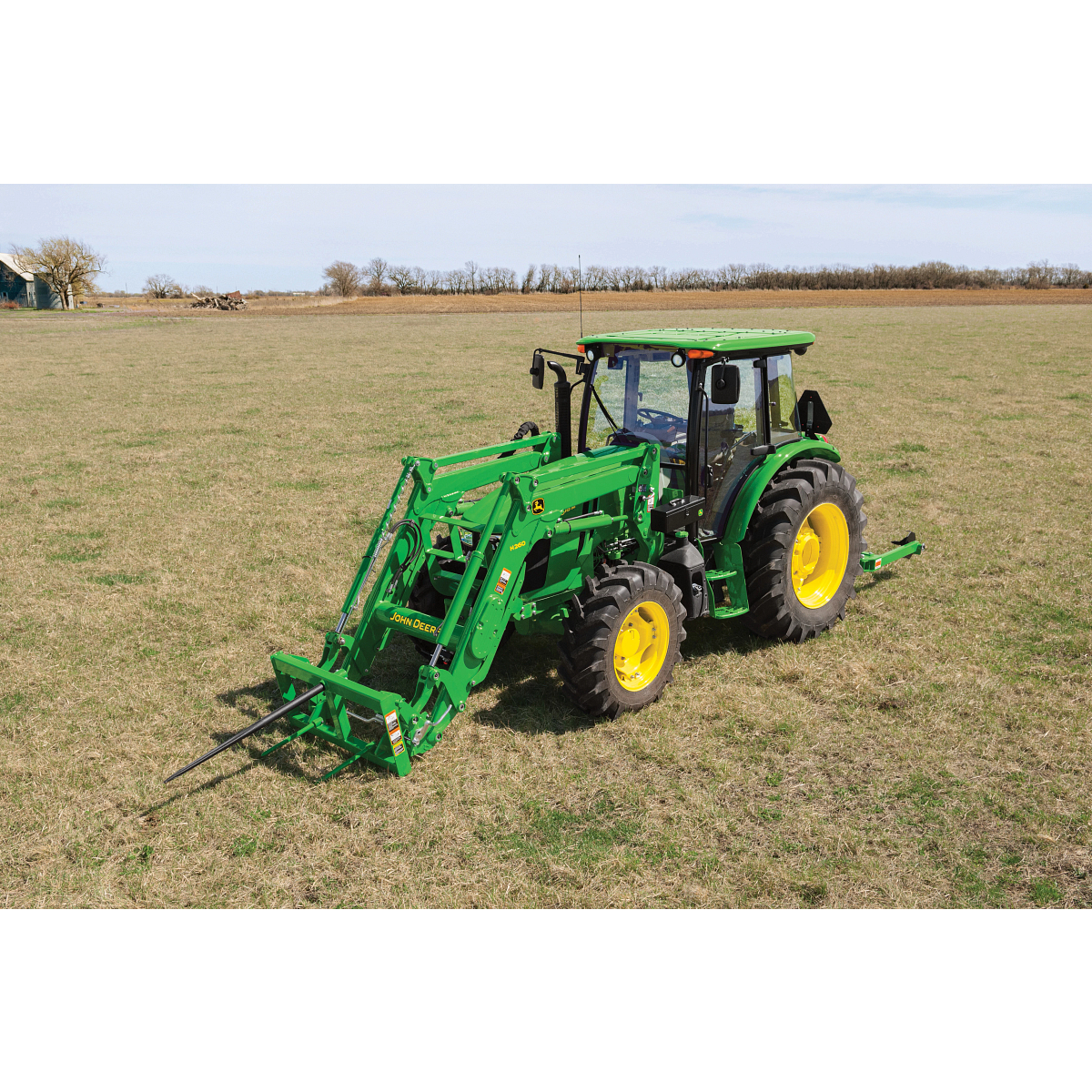 front left view of a tractor with a bale spear