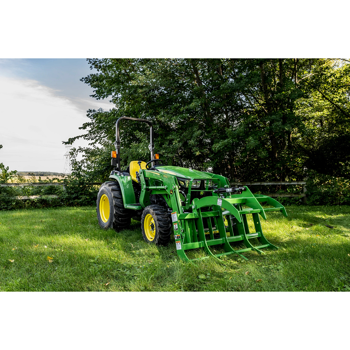 Utility tractor with Root Grapple in grass no operator