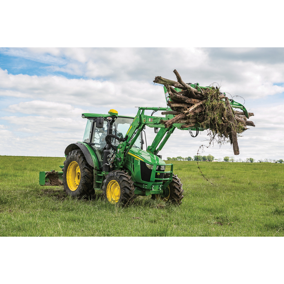Field view of AV20G Root Grapple and RB2308 Rear Blade on a 5100R Tractor