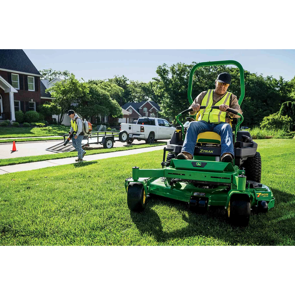 Commercial lawn care crew maintains a property with a Z740M zero-turn mower, in a suburban neighborhood