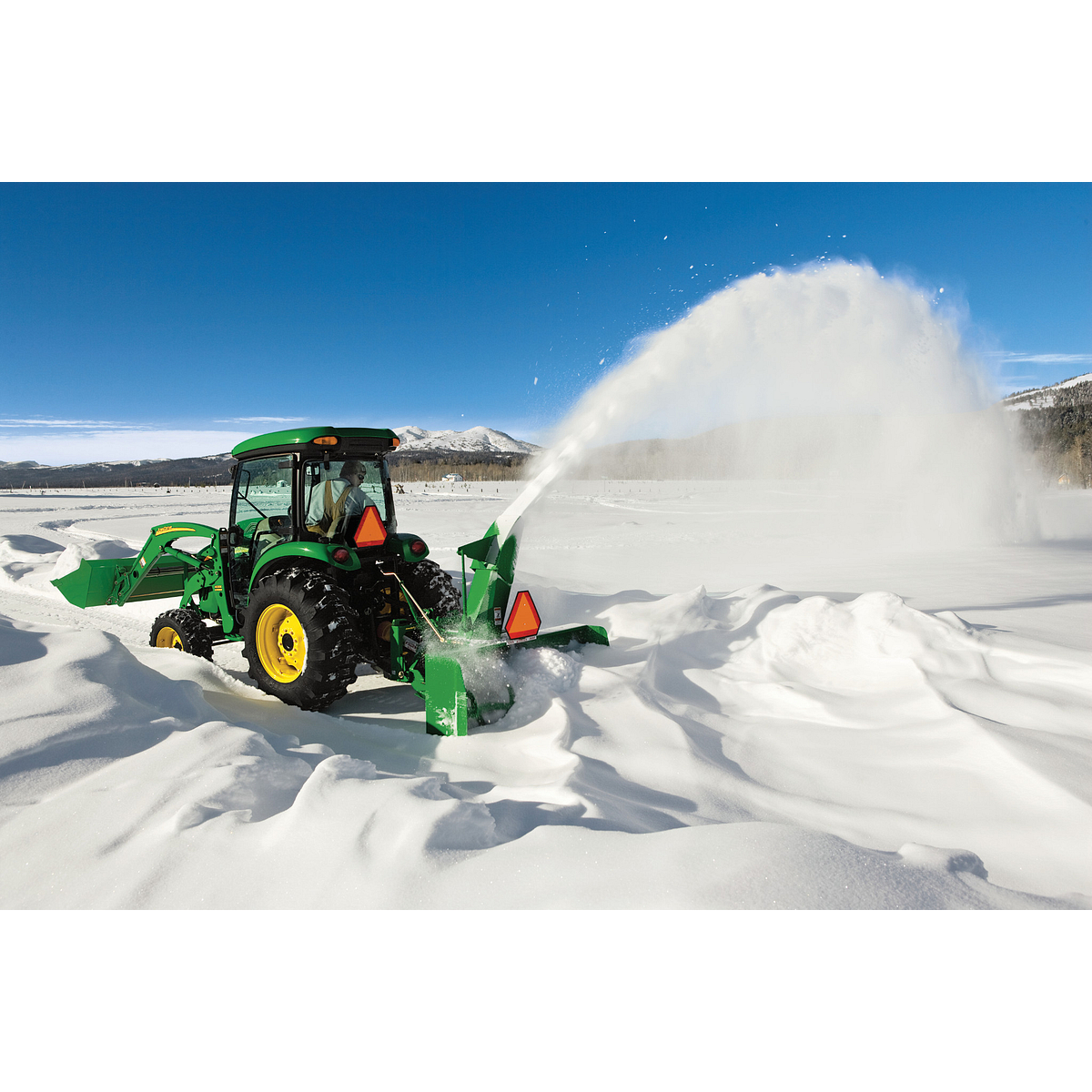 Blowing snow on a driveway using a SB1174 Snowblower on Utility Tractor