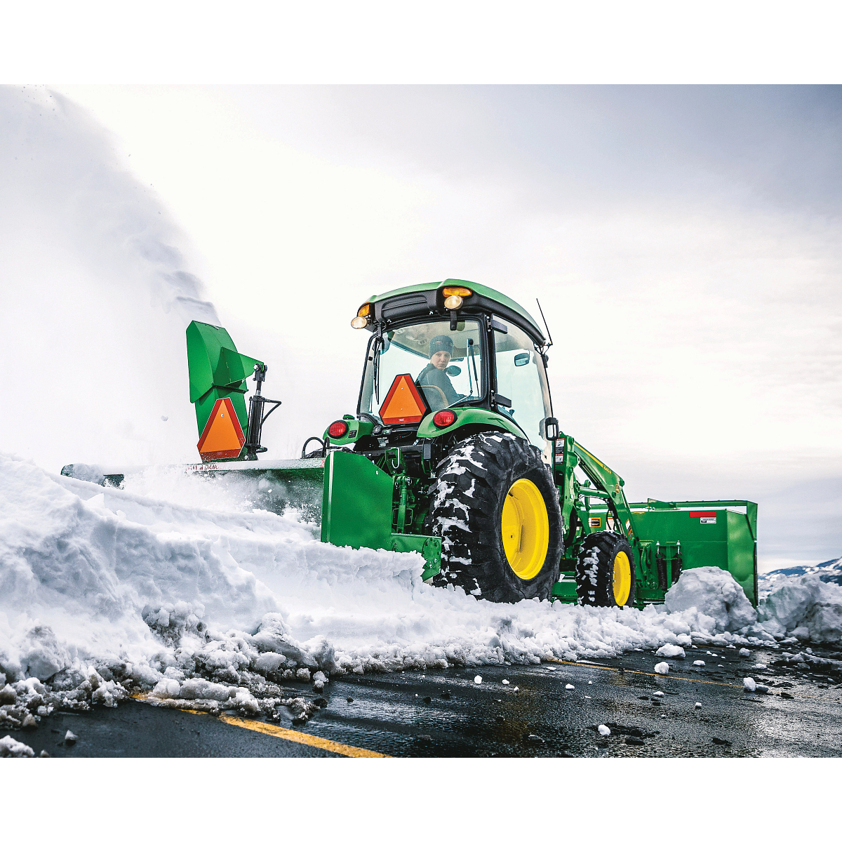 Moving snow using a SB1184 Snowblower on 4066R Tractor in a parking lot