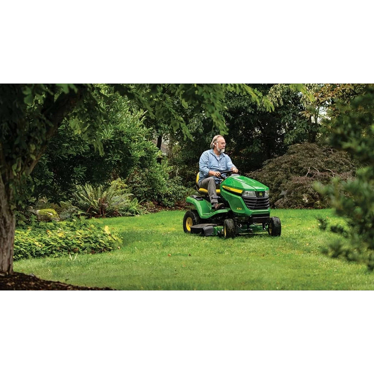 Homeowner driving an X350 Select Series Lawn Tractor mowing a yard