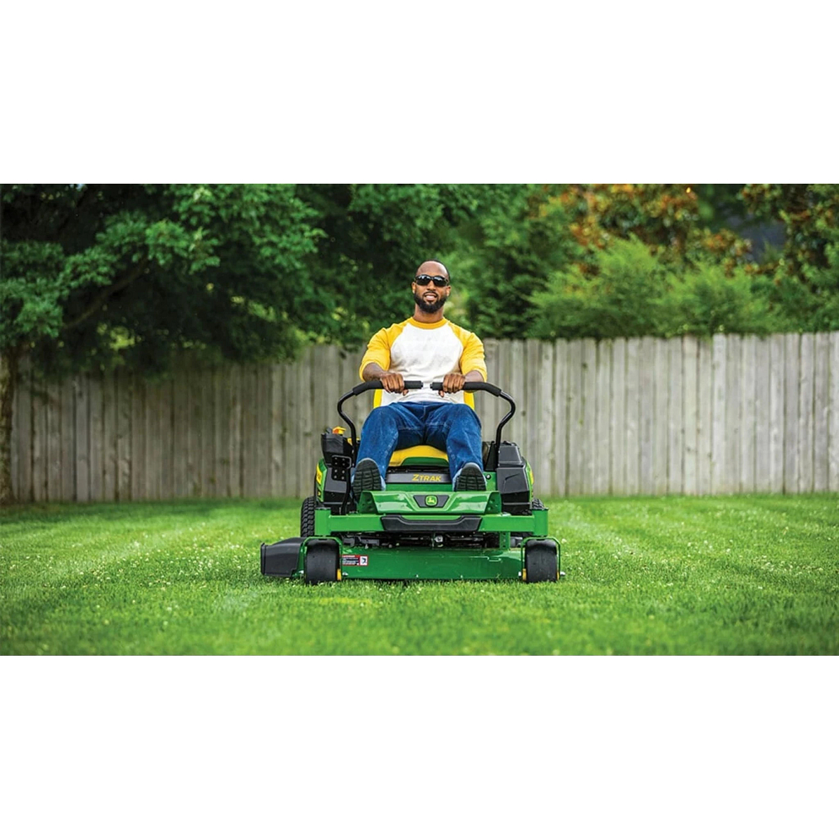 Homeowner mowing a fenced-in yard with a Z320M ZTrak Mower