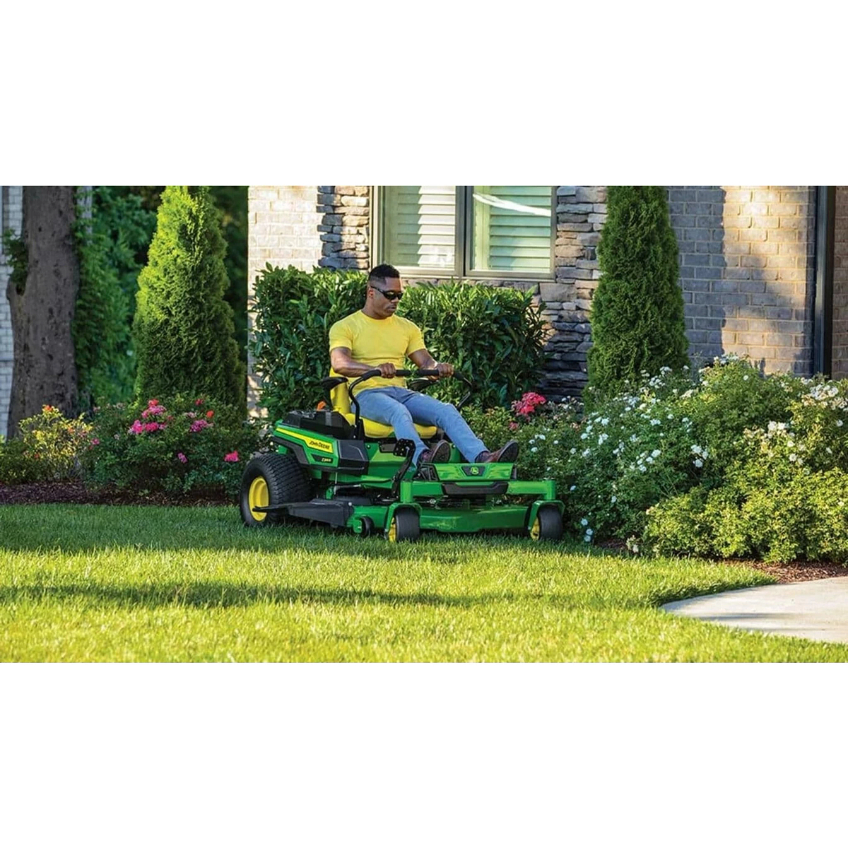 Homeowner mowing along an edge with a Z330R ZTrak Mower in front of a house