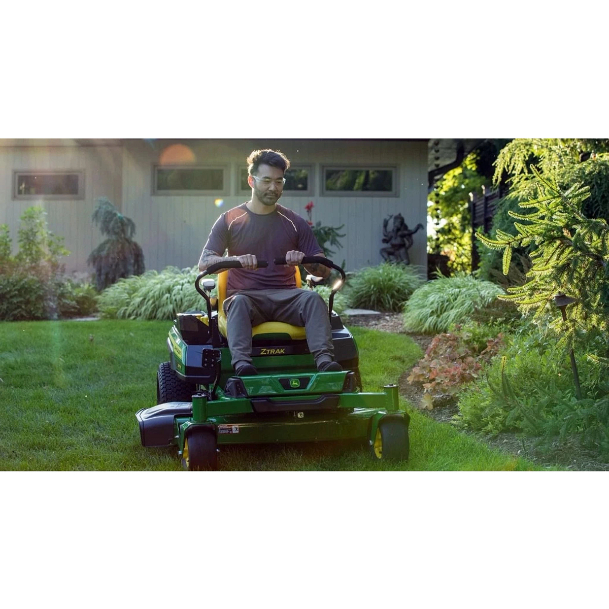 Homeowner cutting his lawn with a Ztrak Mower