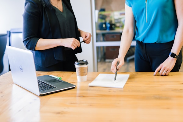 Two people in a meeting discussing a plan in an office 